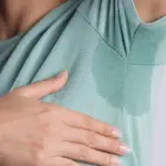 Woman with sweat stains on clothes, showing symptoms of Hyperhidrosis in Leesburg, FL.