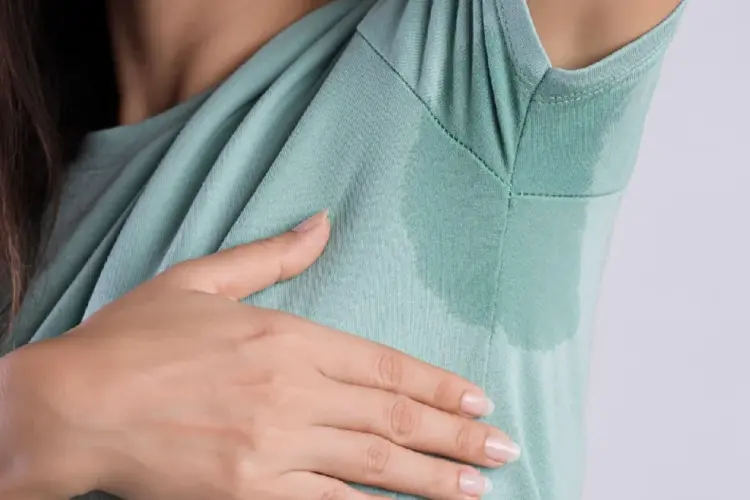 Woman with sweat stains on clothes, showing symptoms of Hyperhidrosis in Leesburg, FL.